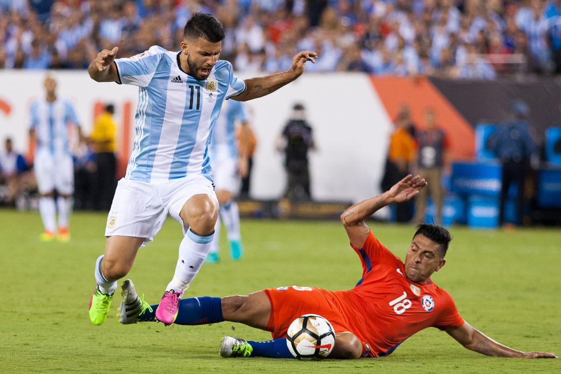 Argentina's Sergio Aguero (11) vies with Chile's Gonzalo Jara.